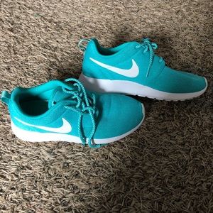 Blue women’s Nike tennis shoes